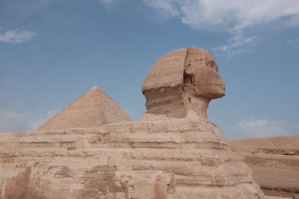 A closer view of the Sphinx with a glimpse of the Great Pyramid.