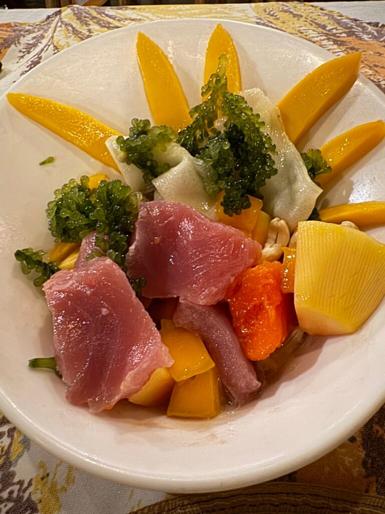 A special dish at Ka Lui Restaurant named Tubbataha Salad which includes fresh tuna slices, mango, lato (Philippine seaweed), kasuy nuts, and papaya slices.