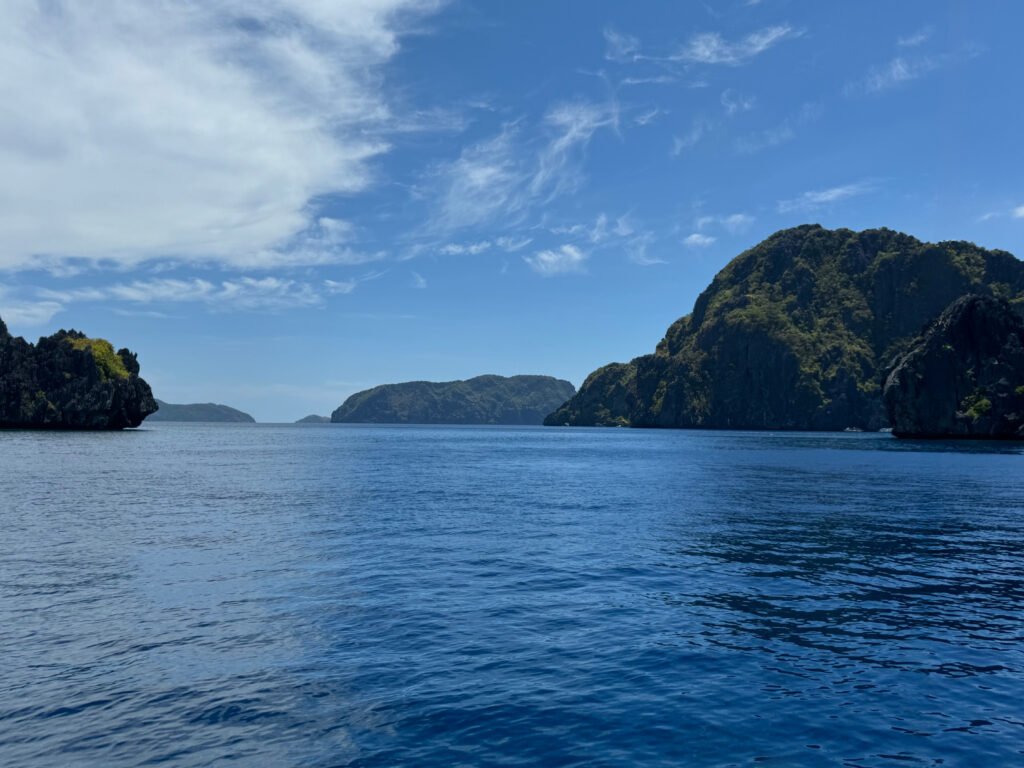 Islands dotting the blue waters of Bacuit Bay in El Nido, Philippines.