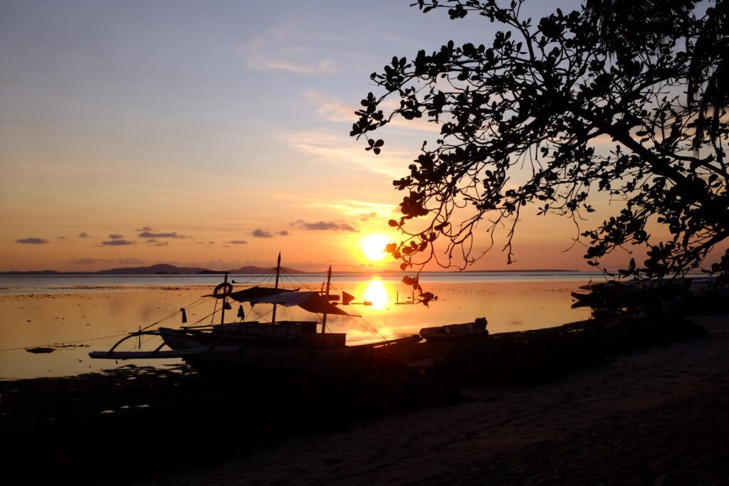 The sun sets over the calm waters at Onuk Island.