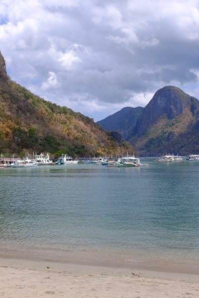 Several boats anchored at El Nido Beach in El Nido, Philippines.