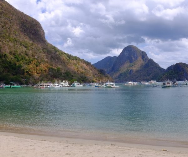 Several boats anchored at El Nido Beach in El Nido, Philippines.